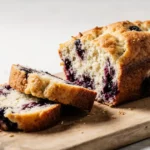 Blueberry Bread with Cottage Cheese: 7 Reasons You’ll Love This Protein-Packed Treat 7 Moist blueberry bread with cottage cheese sliced on a wooden board